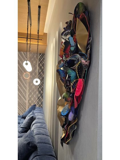 The butterfly sculpture installed in its new home, adding a vibrant, artistic touch to the living space.