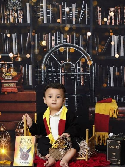 Ready for his first year at Hogwarts, this little one is surrounded by books and magical artifacts. The wide shot of the Harry Potter setup showcases the depth and detail I put into every themed session.