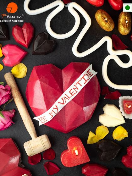 Break into love with our geometric chocolate heart. This "Be My Valentine" smash cake comes with a wooden hammer and is surrounded by smaller chocolate hearts and candles.