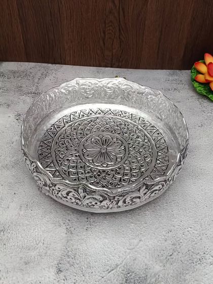 A duplicate image of the antique German silver urli with a central flower design.