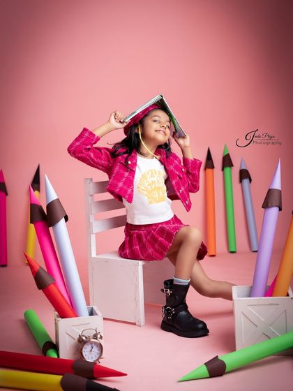 A playful moment balancing a book on her head. I encourage kids to be themselves, which results in authentic and memorable photos.