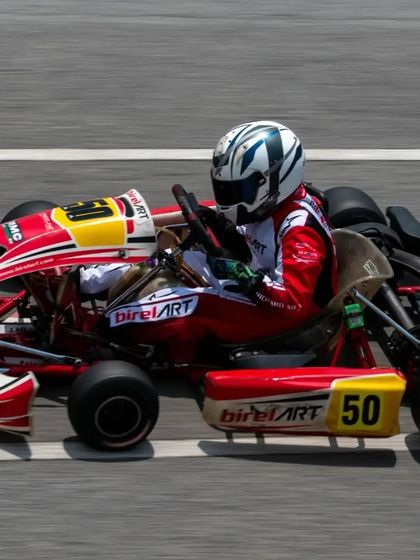 A side profile of our number 50 kart at full throttle on the main straight, highlighting the aerodynamic design and stability of our Birel ART chassis.