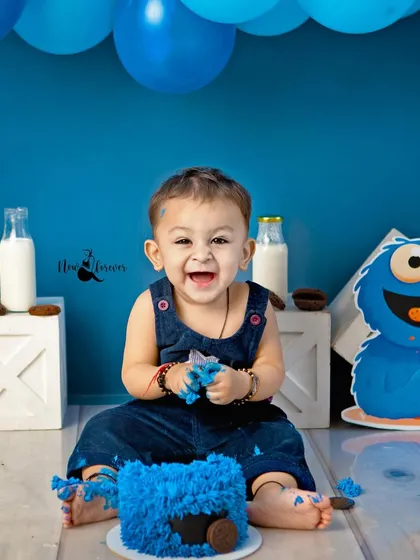 The pure, uncontainable joy of a first birthday cake smash! This little Cookie Monster's laughter is absolutely infectious, making for a truly memorable and fun-filled session.