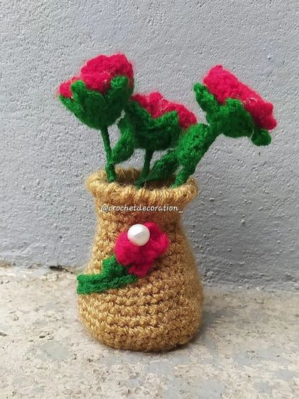 A small vase-style pot with three red rosebuds. This design adds a different silhouette to our collection.