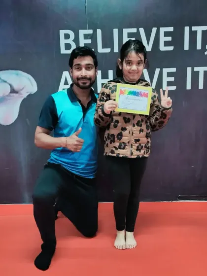 A thumbs up from the coach for this student's new certificate.