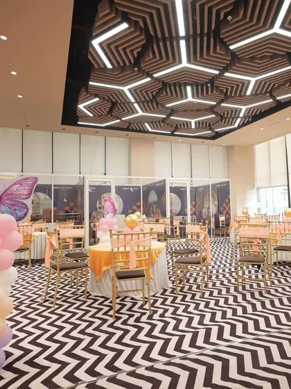 The party space for Sia's birthday, showing how we use balloon columns and themed elements to decorate the entire hall, not just the main stage.