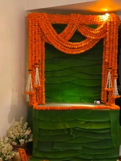 This is an authentic and traditional South Indian style decor for your home or society, featuring fresh banana leaves and fragrant marigolds.