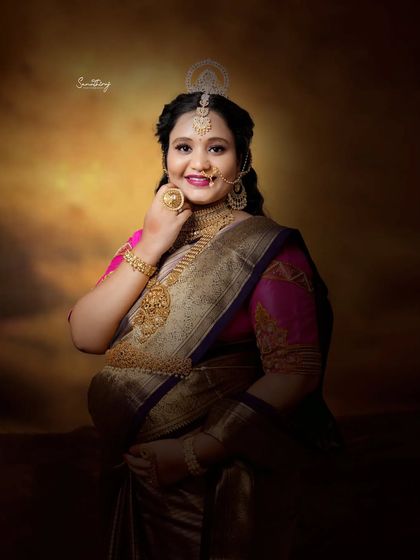 A stunning close-up of a mother-to-be in full traditional regalia. The intricate jewelry and radiant smile capture the essence of celebrating motherhood with cultural pride.