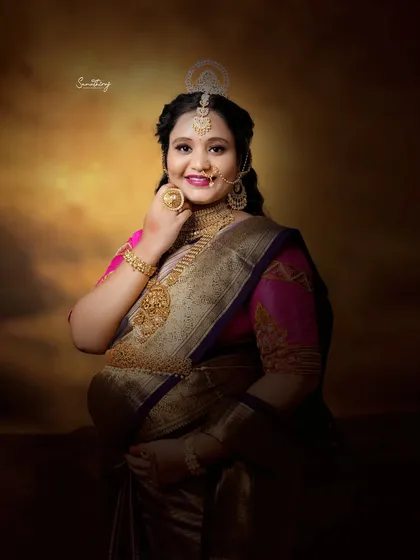 A stunning close-up of a mother-to-be in full traditional regalia. The intricate jewelry and radiant smile capture the essence of celebrating motherhood with cultural pride.
