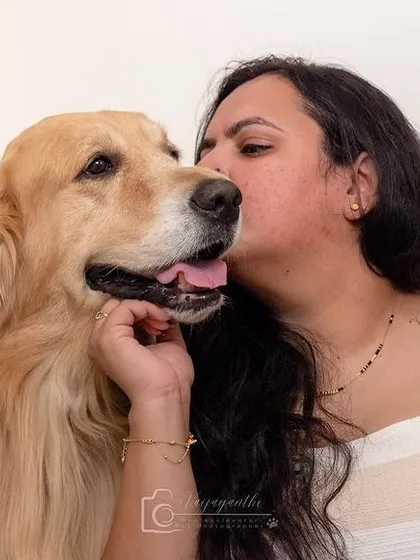 A sweet and gentle moment between Avni and her golden retriever, Shadow. This photo beautifully showcases the quiet, loving bond they share.
