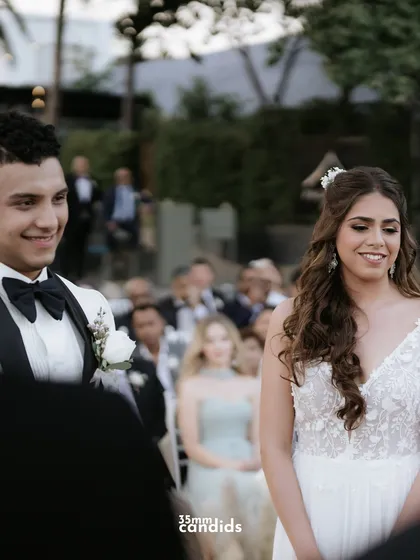 The moment the groom sees his bride walking down the aisle. Her smile and his loving gaze say everything.