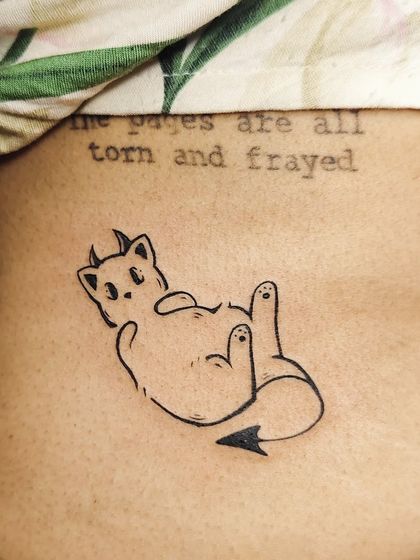 The finished devil cat tattoo, placed on the side with a quote. A fun and personal piece.
