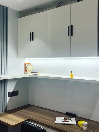 Another angle of the Noida study room, showing the L-shaped desk configuration that maximizes workspace. The combination of open shelving and closed cabinets provides both easy access and concealed storage.