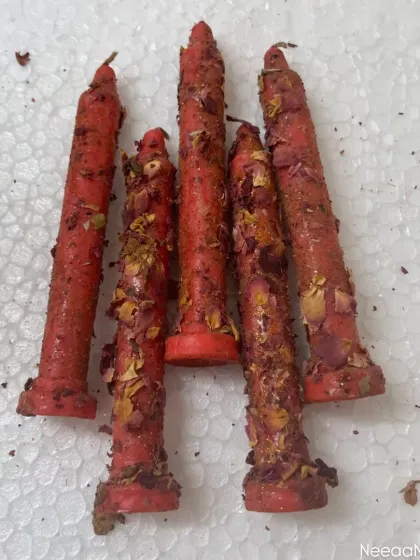 Let the divine glow of Navratri brighten your space. These handmade red taper candles are infused with love, colors, devotion, and dried rose petals.