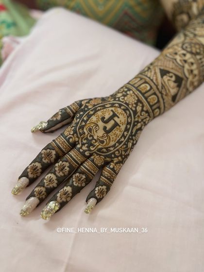 A bold and beautiful design for the back of the hand, featuring the couple's initials 'JJ' inside a detailed mandala.