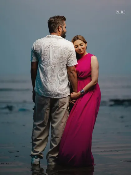 Reflections of love by the sea. Jaspal rests her head on Nishant's shoulder as they stand in the water, a quiet moment of connection captured beautifully.