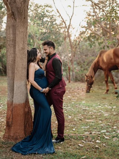 We had a surprise visitor during this outdoor shoot! The horse grazing peacefully in the background added a unique, rustic touch to this couple's elegant maternity portrait in the park.