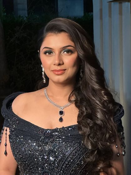 A close-up portrait showing the detail of the blue smokey eye. It's a bold yet elegant choice that makes a statement.