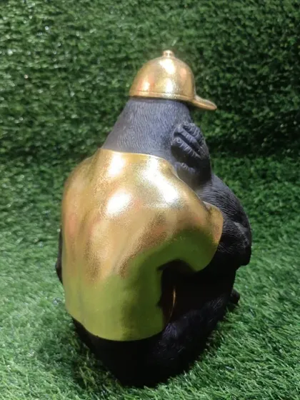 The back view shows the quality of the resin casting and the golden finish on the shirt.
