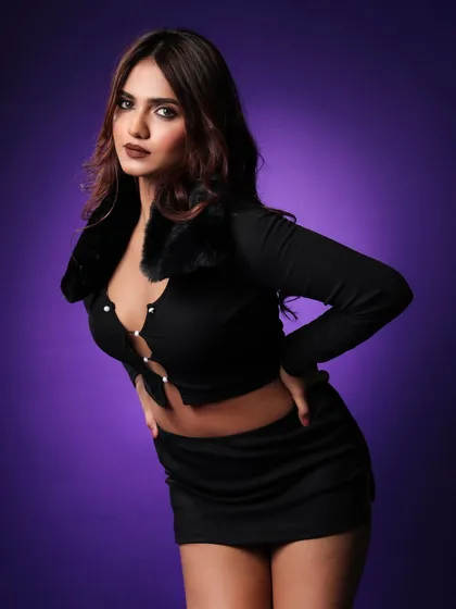 A confident, direct-to-camera pose for the 'aera' lookbook. This angle showcases the fit and cut of the top and skirt, giving a clear view of the design.