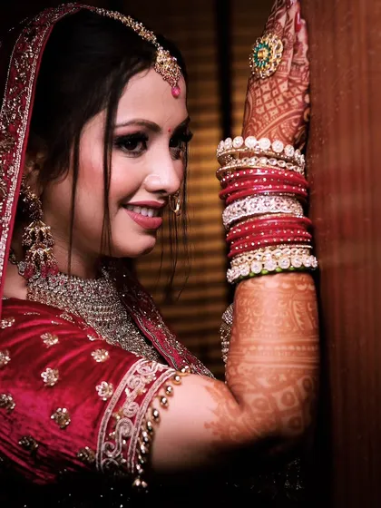 A happy, candid moment of the bride. Her natural smile and the warm lighting make this a beautiful and authentic portrait.