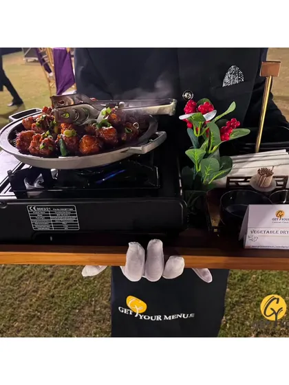 A unique serving style where our chef brings the live station to the guests, preparing and serving hot vegetable dry manchurian from a portable setup.