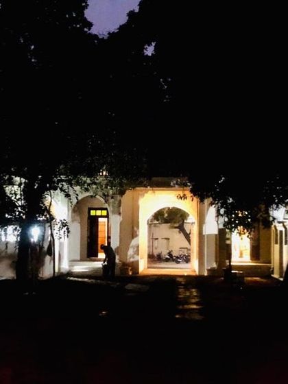 Even from a distance, framed by old trees, the restored entrance of Rhodesia House offers a glimpse into a revived past. This view captures the building's integration into the town's fabric, standing as a testament to the power of heritage conservation.