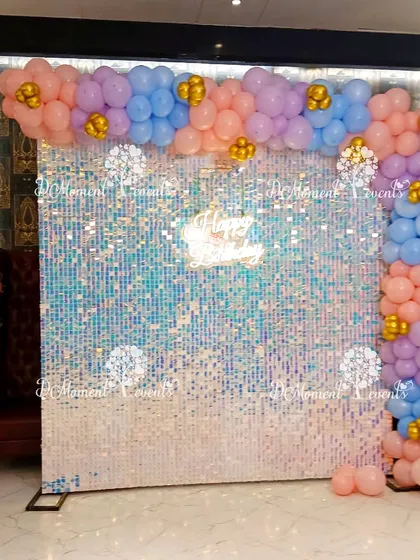 This shimmering sequin wall, framed by pastel balloons, provides a glamorous and fun photo backdrop for a unicorn or rainbow-themed party.