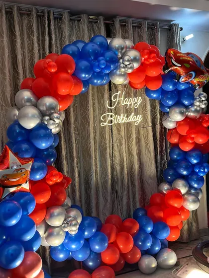 The neon 'Happy Birthday' sign adds a bright focal point to this at-home car theme party.