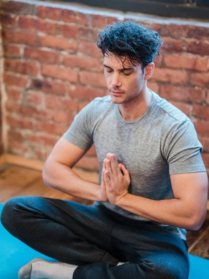 This image captures a moment of quiet meditation. Practicing meditation regularly helps reduce stress, improve focus, and cultivate a sense of inner peace and happiness.