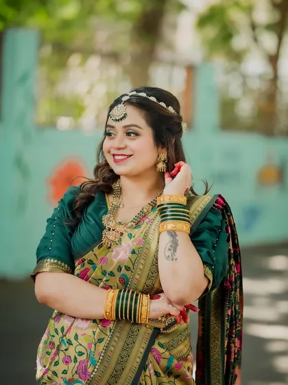 A radiant portrait of a bride-to-be during her "2 States" themed engagement shoot. Her beautiful smile and traditional Bengali-style saree and jewelry are stunningly captured.