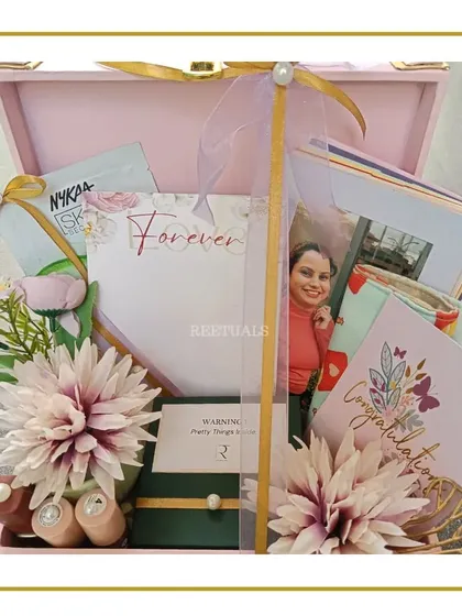 The open trunk box reveals a collection of gifts, including skincare masks, nail polishes, and a personalized note, making it a complete pamper kit.