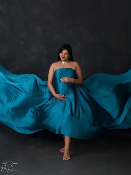 The fabric toss is a classic way to add drama and movement to a maternity photo. Here, the teal silk flows beautifully around her.