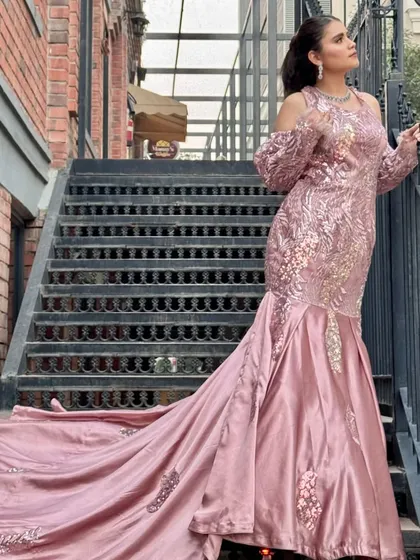 For a glamorous reception or engagement, I styled this client in a stunning pink mermaid gown with a long train. The makeup is kept modern and chic with a sleek ponytail to complement the outfit.