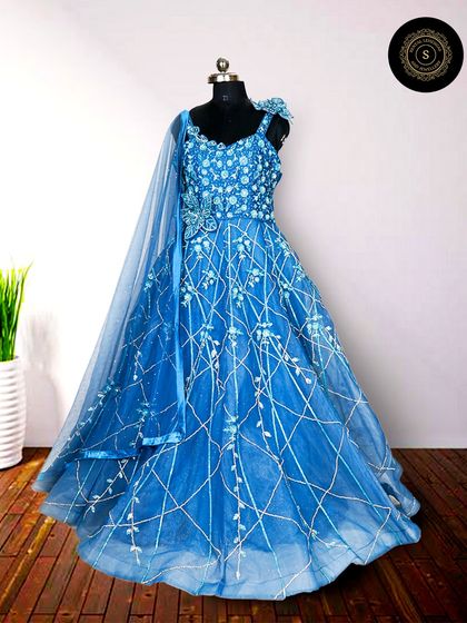 A vibrant royal blue gown with delicate white embroidery. This color is bold and beautiful, ensuring you won't go unnoticed.