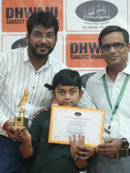 Two of our instructors presenting an award to a proud young student.