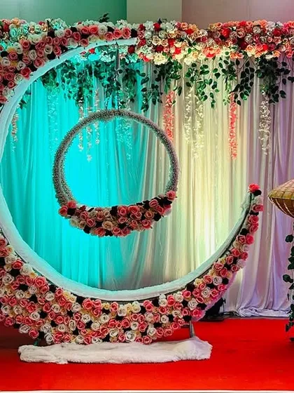 For a naming ceremony, I create magical setups like this one. The centerpiece is a large floral crescent moon holding a decorated baby palna, or cradle. This design makes the baby the star of the show and provides a beautiful backdrop for photos.