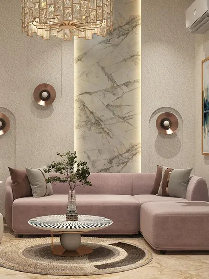 This lounge area features a soft pink L-shaped sofa, set against a wall with textured panels and a striking marble inlay. The round, patterned coffee table and metallic accents add a touch of modern glamour.