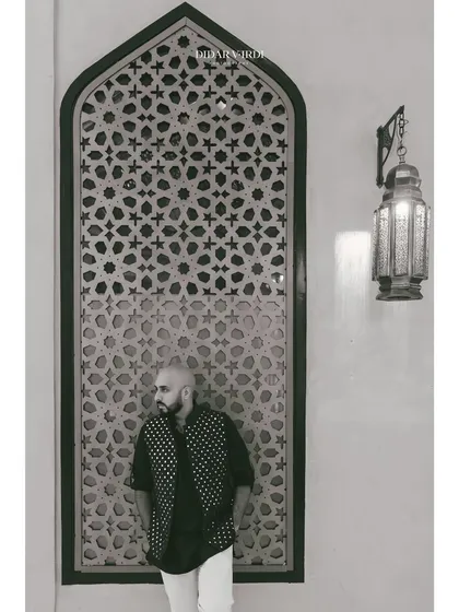 A black and white shot against an ornate window screen in Marrakech. The play of light and shadow is incredible.