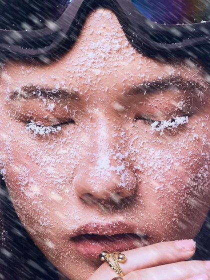 Eyes closed, the focus shifts entirely to the texture of the frosted skin and lashes. It’s a quiet, artistic moment in the middle of a conceptual storm.