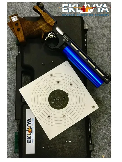 A look at the professional-grade equipment we use, including this precision air pistol. The tight shot grouping on the target demonstrates the level of accuracy our shooters strive for and achieve through dedicated practice.