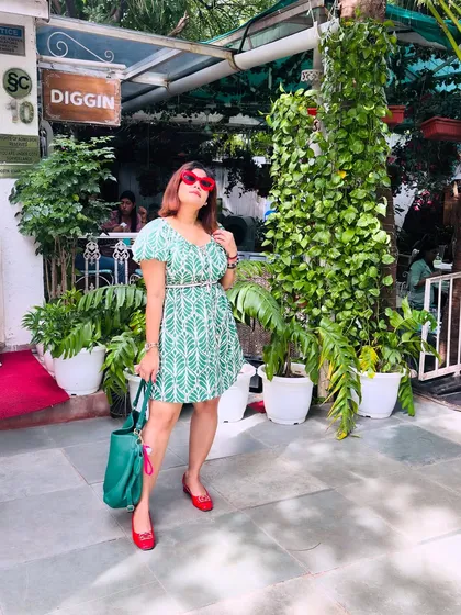 This look is all about creating a mood with color. The calm green of the leaf-print dress paired with the fire of the red accessories makes for a balanced yet bold outfit, perfect for a brunch date or a day exploring the city.