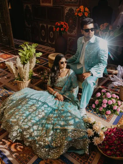 A stylish couple portrait from a Haldi carnival. The unique lighting on their coordinated outfits and the cool sunglasses give this shot a modern, editorial feel, showcasing a different take on Haldi photography.