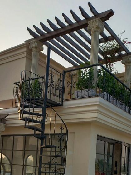 This project showcases a classical Victorian theme on a modern terrace. We incorporated architectural columns, a wooden pergola, and a spiral staircase to create a timeless and elegant outdoor space.