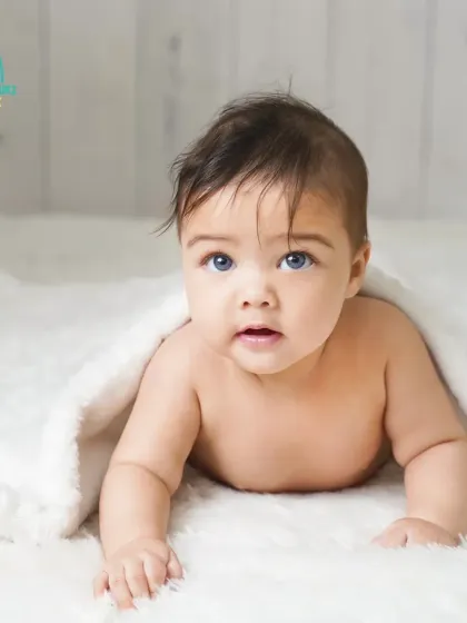 A simple and classic portrait of one of the beautiful twin girls. The all-white theme with a soft blanket creates a pure and angelic look.