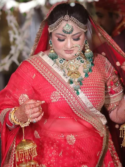 A playful moment with the kaleeras. The bride looks joyful and radiant on her special day.