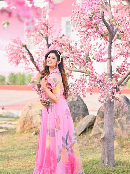 A joyful, full-length shot from the cherry blossom series. The model's happy expression and the beautiful pink scenery make this a perfect shot for a spring fashion story.