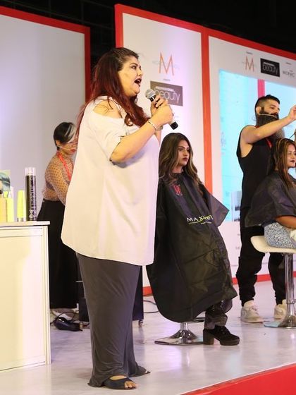 Explaining the process during a live hair demo in Kolkata. Education is about communication, whether it's in a small class or on a big stage.