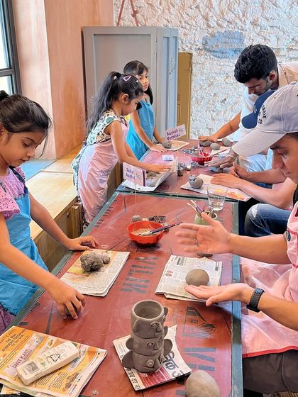 A father helps his daughter with her hand-building project during our Father's Day event. These shared activities are what make the day so special.