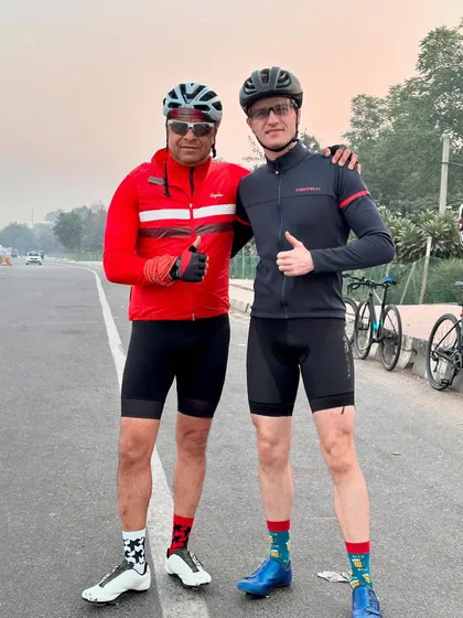 A friendly arm around the shoulder between two members during a ride.